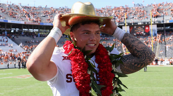Sooners quarterback Dillon Gabriel wears a lei and cowboy hat after Oklahoma’s upset of Texas